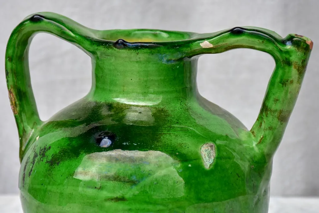 Antique French water jug with green glaze and spout